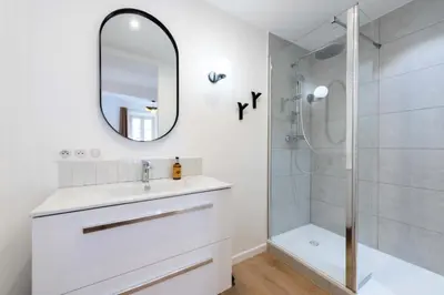 a white bathroom with a sink and a shower at Résidence 3p Terrasse & Calme Cannes Centre - 3P Terrasse & Calme Cannes Centre MAE-3213 in Cannes