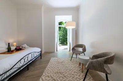 a bedroom with a bed and a table and chairs at Résidence 4p Bourgeois Rez-de-jardin, Proche Croisette & Plages - 4P Bourgeois Rez-de-jardin, proche Croisette & Plages MAE-3243 in Cannes