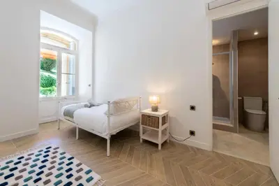 a white room with a bed and a window at Résidence 4p Bourgeois Rez-de-jardin, Proche Croisette & Plages - 4P Bourgeois Rez-de-jardin, proche Croisette & Plages MAE-3243 in Cannes