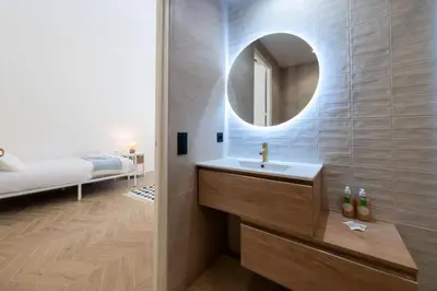 a bathroom with a sink and a mirror at Résidence 4p Bourgeois Rez-de-jardin, Proche Croisette & Plages - 4P Bourgeois Rez-de-jardin, proche Croisette & Plages MAE-3243 in Cannes