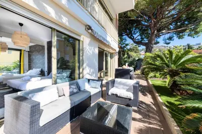 a patio with couches and chairs on a house at Résidence 4p Piscine Privée & Vue Mer - 4P Piscine privée & Vue mer MAE-3263 in Cannes