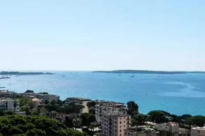 a view of a large body of water with buildings at Résidence 3p Vue Mer, Piscine – Cannes Croix Des Gardes - 3P Vue Mer, Piscine – Cannes Croix des Gardes MAE-3273 in Cannes