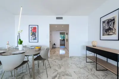 a dining room with a table and chairs at Résidence 3p Vue Mer, Piscine – Cannes Croix Des Gardes - 3P Vue Mer, Piscine – Cannes Croix des Gardes MAE-3273 in Cannes