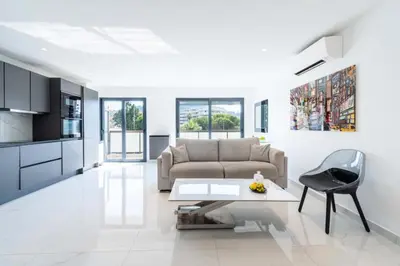 a living room with a couch and a table at Résidence 2p Traversant, Centre Cannes, Rue D’antibes - 2P Traversant, Centre Cannes, Rue d’Antibes MAE-3343 in Cannes