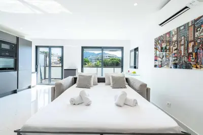 a white dining room with a large white table at Résidence 2p Traversant, Centre Cannes, Rue D’antibes - 2P Traversant, Centre Cannes, Rue d’Antibes MAE-3343 in Cannes