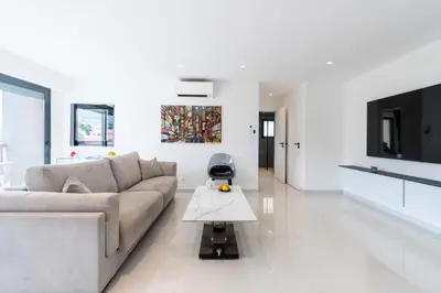 a white living room with a couch and a table at Résidence 2p Traversant, Centre Cannes, Rue D’antibes - 2P Traversant, Centre Cannes, Rue d’Antibes MAE-3343 in Cannes
