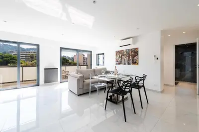 a dining room and living room with a table and chairs at Résidence 2p Traversant, Centre Cannes, Rue D’antibes - 2P Traversant, Centre Cannes, Rue d’Antibes MAE-3343 in Cannes