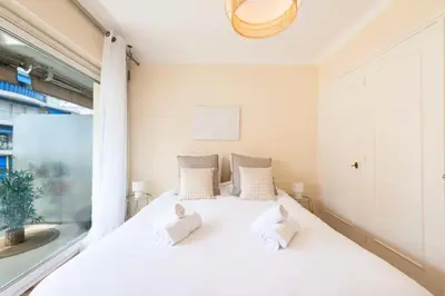 a white bed in a room with a window at Résidence 2p Terrasse – Palm Beach, Proche Plages - 2P Terrasse – Palm Beach, Proche Plages MAE-2753 in Cannes