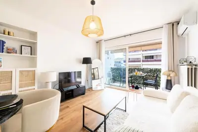 a living room with a white couch and a large window at Résidence 2p Terrasse – Palm Beach, Proche Plages - 2P Terrasse – Palm Beach, Proche Plages MAE-2753 in Cannes