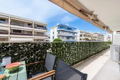 a balcony with a table and chairs and buildings at Résidence 2p Terrasse – Palm Beach, Proche Plages - 2P Terrasse – Palm Beach, Proche Plages MAE-2753 in Cannes