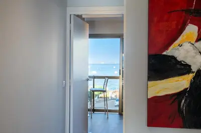 a painting hanging on a wall next to a door at Résidence Beau 3p, Vue Mer, Plages à Pied - Beau 3P, Vue Mer, Plages à pied MAE-3553 in Cannes