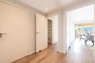 an empty living room with white walls and wooden floors at Résidence Beau 3p, Vue Mer, Plages à Pied - Beau 3P, Vue Mer, Plages à pied MAE-3553 in Cannes