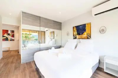 a bedroom with a large white bed and a large window at Résidence Beau 3p, Vue Mer, Plages à Pied - Beau 3P, Vue Mer, Plages à pied MAE-3553 in Cannes