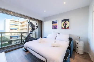 a bedroom with a bed and a large window at Résidence Beau 3p, Vue Mer, Plages à Pied - Beau 3P, Vue Mer, Plages à pied MAE-3553 in Cannes