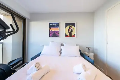 a bedroom with a white bed with towels on it at Résidence Beau 3p, Vue Mer, Plages à Pied - Beau 3P, Vue Mer, Plages à pied MAE-3553 in Cannes
