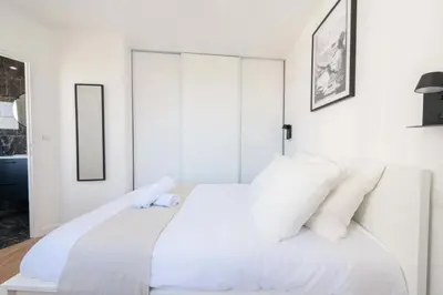 a white bedroom with a large bed with white pillows at Résidence Cannes 2p Proche Centre - Cannes 2P Proche Centre MAE-4093 in Cannes