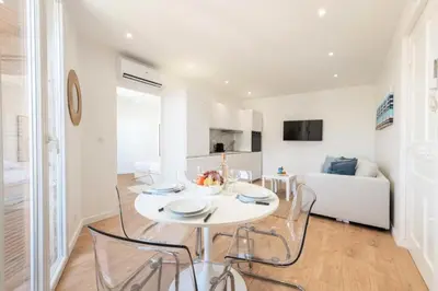 a kitchen and living room with a white table and chairs at Résidence Cannes 2p Proche Centre - Cannes 2P Proche Centre MAE-4093 in Cannes