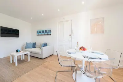 a white living room with a table and a couch at Résidence Cannes 2p Proche Centre - Cannes 2P Proche Centre MAE-4093 in Cannes