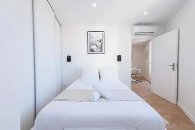 a white bedroom with two beds with white walls at Résidence Cannes 2p Proche Centre - Cannes 2P Proche Centre MAE-4093 in Cannes