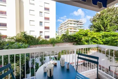 a blue table and chairs on a balcony at Résidence 2p Au Calme, Proche Plages Et Centre Ville - 2P au Calme, proche Plages et Centre ville MAE-5693 in Cannes