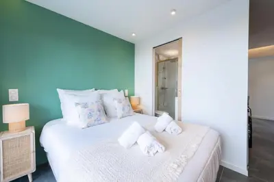 a bedroom with a white bed with towels on it at Résidence 2p Au Calme, Proche Plages Et Centre Ville - 2P au Calme, proche Plages et Centre ville MAE-5693 in Cannes