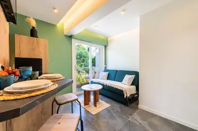 a living room with green walls and a couch at Résidence 2p Au Calme, Proche Plages Et Centre Ville - 2P au Calme, proche Plages et Centre ville MAE-5693 in Cannes