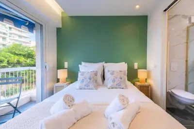 a bedroom with a large bed with towels on it at Résidence 2p Au Calme, Proche Plages Et Centre Ville - 2P au Calme, proche Plages et Centre ville MAE-5693 in Cannes