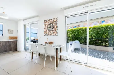 a dining room with a table and white chairs at Résidence 4p Rooftop Avec Jacuzzi & Parking, Cannes - 4P Rooftop avec Jacuzzi & Parking, Cannes MAE-7563 in Cannes