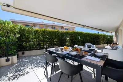 a patio with a table and chairs on a balcony at Résidence 4p Rooftop Avec Jacuzzi & Parking, Cannes - 4P Rooftop avec Jacuzzi & Parking, Cannes MAE-7563 in Cannes