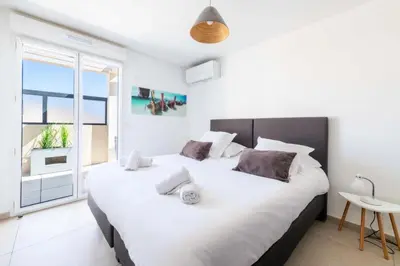 a white bedroom with a large bed and a tv at Résidence 4p Rooftop Avec Jacuzzi & Parking, Cannes - 4P Rooftop avec Jacuzzi & Parking, Cannes MAE-7563 in Cannes