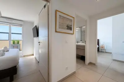 a bedroom with a large white bed and a window at Résidence 4p Rooftop Avec Jacuzzi & Parking, Cannes - 4P Rooftop avec Jacuzzi & Parking, Cannes MAE-7563 in Cannes