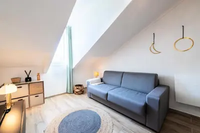 a living room with a blue couch and a rug at Résidence Studio Dernier étage – Cœur De Cannes - Studio dernier étage – Cœur de Cannes MAE-4493 in Cannes
