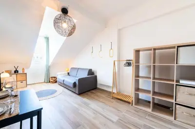 a living room with a couch and a chair at Résidence Studio Dernier étage – Cœur De Cannes - Studio dernier étage – Cœur de Cannes MAE-4493 in Cannes