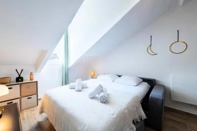 a bedroom with a white bed with towels on it at Résidence Studio Dernier étage – Cœur De Cannes - Studio dernier étage – Cœur de Cannes MAE-4493 in Cannes