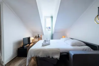 a bedroom with a bed with two pillows on it at Résidence Studio Dernier étage – Cœur De Cannes - Studio dernier étage – Cœur de Cannes MAE-4493 in Cannes
