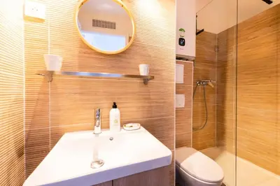 a bathroom with a sink and a toilet and a mirror at Résidence Studio Dernier étage – Cœur De Cannes - Studio dernier étage – Cœur de Cannes MAE-4493 in Cannes