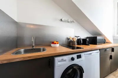 a kitchen with a sink and a washing machine at Résidence Studio Dernier étage – Cœur De Cannes - Studio dernier étage – Cœur de Cannes MAE-4493 in Cannes