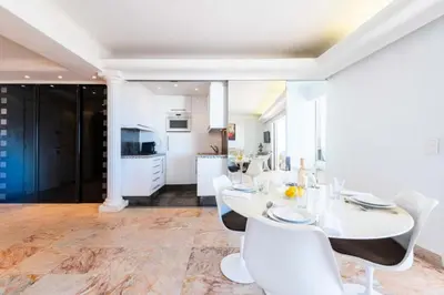 a white dining room with a table and white chairs at Résidence 3p Vue Panoramique - Dernier Étage, Cannes - 3P Vue Panoramique - Dernier Étage, Cannes MAE-3933 in Cannes