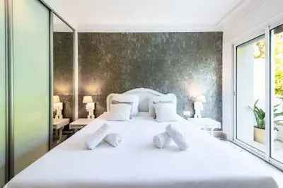 a bedroom with a large white bed with white pillows at Résidence 3p Vue Panoramique - Dernier Étage, Cannes - 3P Vue Panoramique - Dernier Étage, Cannes MAE-3933 in Cannes