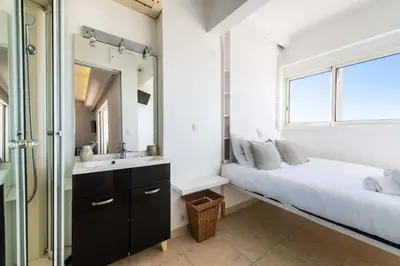 a bathroom with a bed and a sink and a mirror at Résidence 3p Vue Panoramique - Dernier Étage, Cannes - 3P Vue Panoramique - Dernier Étage, Cannes MAE-3933 in Cannes