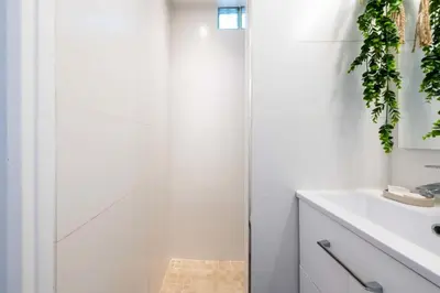 a white bathroom with a shower and a sink at Résidence Studio Dernier étage – Centre Cannes - Studio dernier étage – Centre Cannes MAE-3943 in Cannes