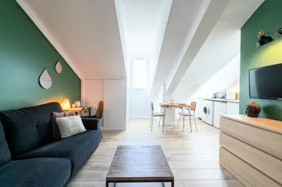 a living room with a couch and a table at Résidence Studio Dernier étage – Centre Cannes - Studio dernier étage – Centre Cannes MAE-3943 in Cannes