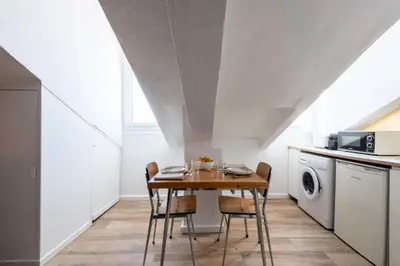 a dining room with a table and chairs in a kitchen at Résidence Studio Dernier étage – Centre Cannes - Studio dernier étage – Centre Cannes MAE-3943 in Cannes