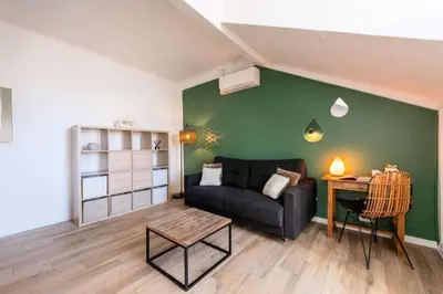a living room with a couch and a table at Résidence Studio Dernier étage – Centre Cannes - Studio dernier étage – Centre Cannes MAE-3943 in Cannes