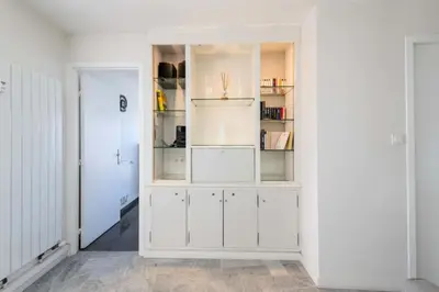 a white cabinet in a room with a door at Résidence 3p Vue Panoramique & Accès Plages - 3P Vue Panoramique & Accès Plages MAE-5013 in Cannes
