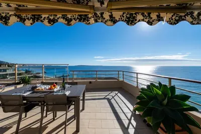 a balcony with a table and a view of the ocean at Résidence 3p Vue Panoramique & Accès Plages - 3P Vue Panoramique & Accès Plages MAE-5013 in Cannes