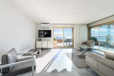 a living room with a couch and a tv at Résidence 3p Vue Panoramique & Accès Plages - 3P Vue Panoramique & Accès Plages MAE-5013 in Cannes