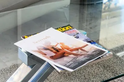 a magazine sitting on top of a glass table at Résidence 3p Vue Panoramique & Accès Plages - 3P Vue Panoramique & Accès Plages MAE-5013 in Cannes
