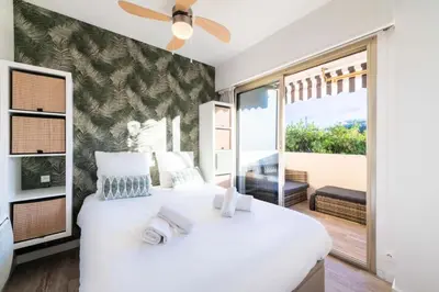 a bedroom with a large white bed with a large window at Résidence 2p Proche Plage Et Croisette, Palm Beach - 2P Proche Plage et Croisette, Palm Beach MAE-2193 in Cannes