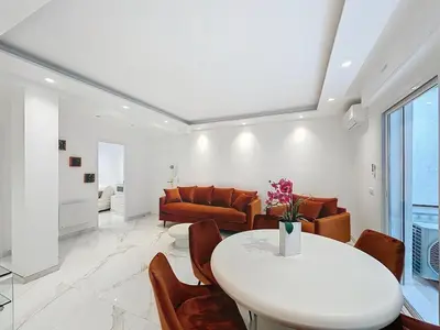 a white bedroom with a bed and a window at Executive 2BR Apartment near Croisette Ideal for MIPIM Terrace & Wi-Fi in Cannes